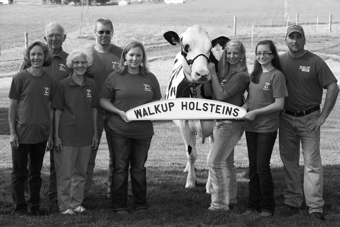 Walkup Holsteins family: (L-R) Teresa Callender, Dan Myers, Charlotte Myers, Donnie Callender, Kristina Callender, Kelly Callender, Anna Myers, D.J. Myers. The cow is Walkup Blitz Trisha 2E 92.